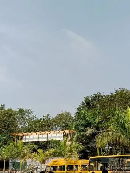 A lone kite soars high above the school campus, symbolizing the aspirations and high spirits of our students.