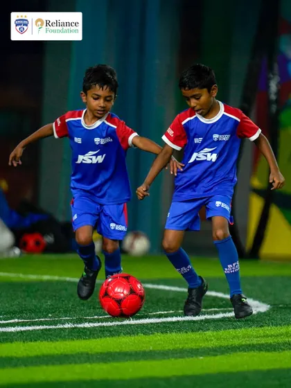 Two players work together to advance the ball, demonstrating the teamwork we foster. We teach players to think and play as a cohesive unit.