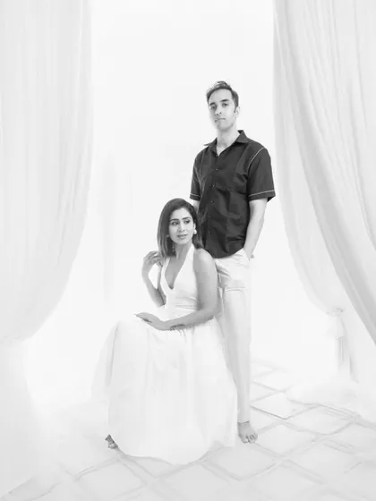 A sophisticated and elegant couple's portrait. The black and white format adds a layer of timeless romance and classic style to their studio session.