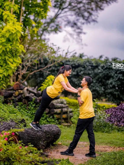 A playful and energetic moment in a garden. This shot is full of fun and captures the couple's adventurous spirit.