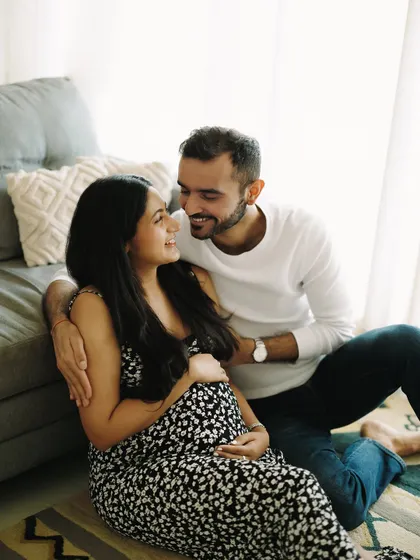 A cozy, at-home session where the couple is sitting on the floor, just being together. The smiles they share speak volumes about the home and life they are building.