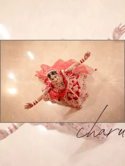 An artistic aerial shot of a bride in her red lehenga, creating a beautiful, flower-like pattern on the floor.