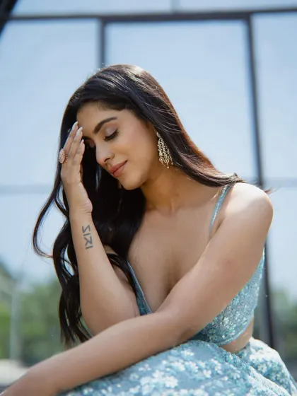 A candid and beautiful moment from the shoot. The makeup looks flawless and natural even in the bright, outdoor lighting.