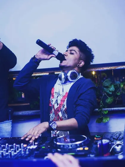 On the mic, connecting with the crowd. I make sure every set is an interactive experience, not just a playlist.