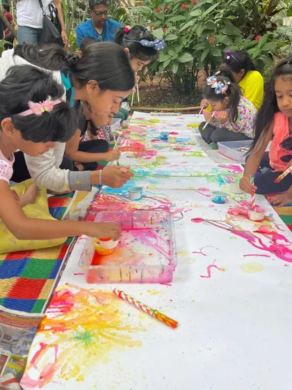 A group of children engaged in a collaborative bubble painting project. This messy, fun activity is a favorite and perfectly embodies the spirit of process art.