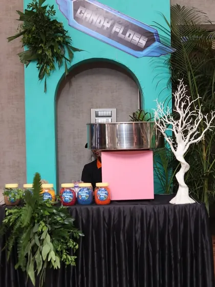 Our candy floss station set up for a theme birthday. The stall is decorated with lush greenery to blend seamlessly with the party's decor.