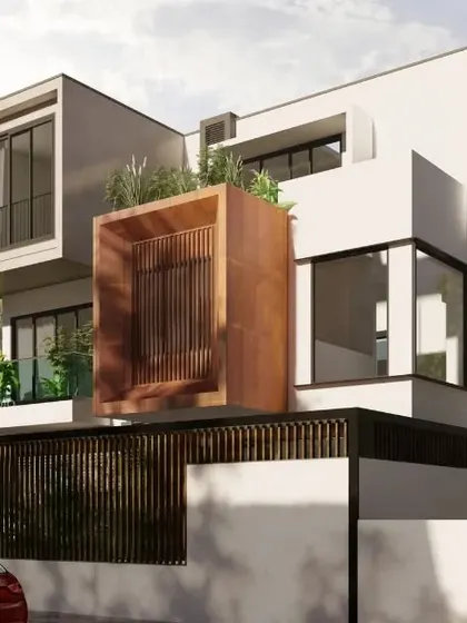 This view highlights the minimalist structure and open spaces of the Nidhi Nilayam project. The projecting volumes and the distinctive corten steel finished box create a dynamic composition, showing how simple forms can be combined for an elegant and chic home design.