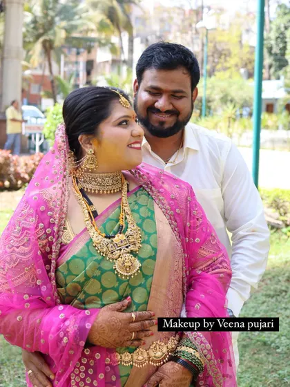 A happy couple portrait. The bride's makeup is radiant and natural, perfect for outdoor photos.