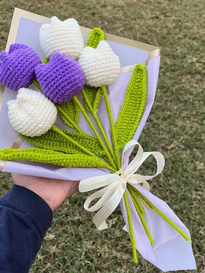 Our 'Lilac Love' bouquet, featuring five purple and white tulips, looks beautiful against a natural backdrop. A perfect, simple, and elegant gift.
