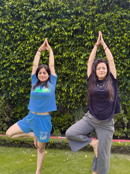 Finding our balance together with a tree pose in the park.