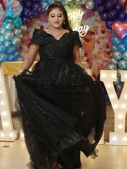The same happy client showing off the beautiful flare of her black rental gown.