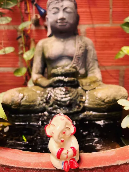 My little Ganesha sitting in front of the Buddha statue in my studio garden. These two are my constant companions.