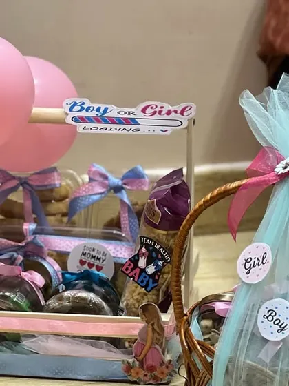Another view of my baby shower gift arrangements. I focus on creating a beautiful presentation with coordinated colors, ribbons, and themed decorations like the "Boy or Girl" loading bar.