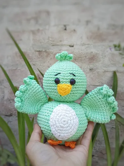 This is Koda, a sweet little bird amigurumi I made. I used a lovely mint green cotton yarn for his body and gave him little wings that are ready for a hug. All the features are securely attached, making him a durable little friend.