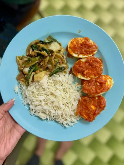 A simple Asian-inspired meal of basmati rice, egg masala, and sautéed bok choy.