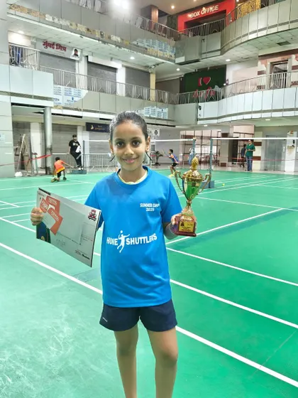 Another winner from our Summer Camp 2022 batch, celebrating her victory at the Racket Rider Tournament. Her Home Shuttlers jersey represents her commitment to the team.