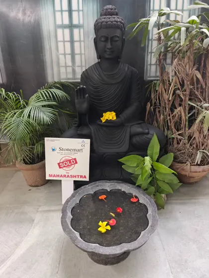 This 4-foot, 500 kg black marble Buddha statue, sold to a client in Maharashtra, is shown with a separate granite uruli bowl. This setup allows for floating flowers or candles at the base.