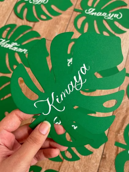 I absolutely loved creating these unique monstera leaf name tags for birthday party favors. The leaves were laser-cut from green cardstock, and I added each name in modern white calligraphy.