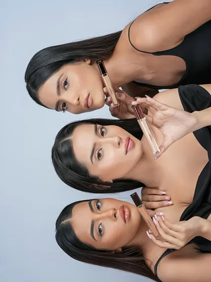 A similar group concept used for a concealer or foundation launch. The models display different shades, highlighting the brand's range.