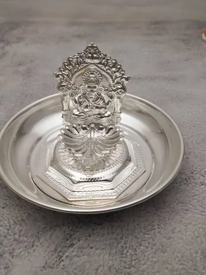 A German silver Lakshmi diya on a plate, a classic and always appreciated return gift for festivals like Diwali or Navratri.