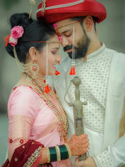 An intimate and romantic portrait of the couple on their wedding day. The groom's traditional sword and the bride's soft expression create a powerful contrast.