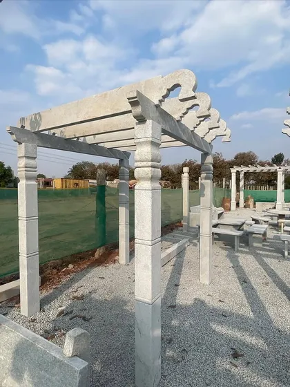 A stone pergola with decorative rafters, shown here at my workshop before delivery and installation.