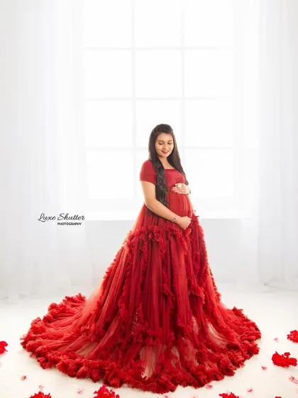 A vision in red. This ruffled gown looks absolutely stunning in our bright, airy studio setup, with soft light pouring in from the window.