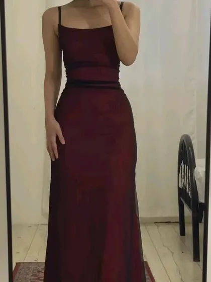 A client's mirror selfie showcasing the simple elegance of this maroon spaghetti strap gown. The clean lines and perfect fit are central to my design philosophy.