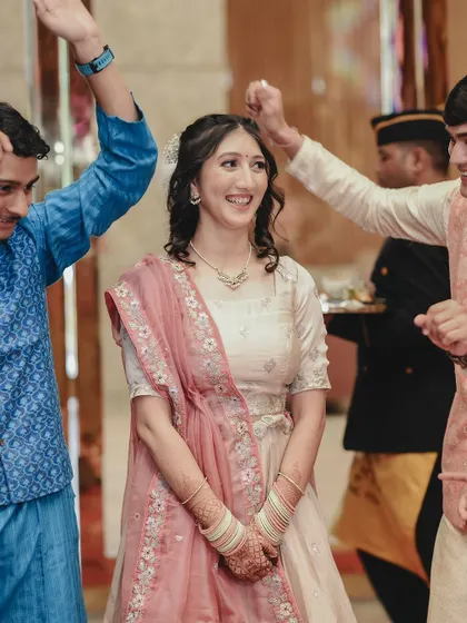 The bride's happy expression as she is surrounded by friends and family during her engagement ceremony. I capture the candid interactions that make the day special.