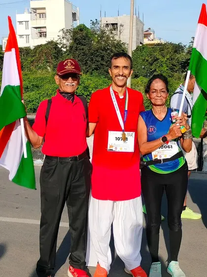 Runners of all ages participate in our events. Here, a participant poses with two senior runners, proving that fitness has no age limit.