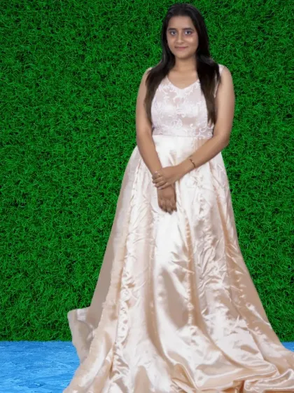 A simple and elegant satin gown in a soft peach color. Its classic A-line shape and subtle sheen make it a timeless choice.