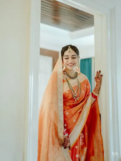 The bride waving as she makes her entrance. The look is fresh, elegant, and perfectly suited for a bride who was hesitant about makeup.