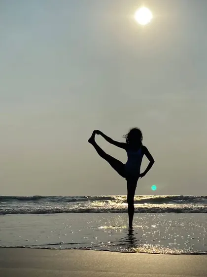 A silhouette of a standing split on the beach at sunset. Moments like these make me dream of planning my next yoga retreat in a tropical paradise.