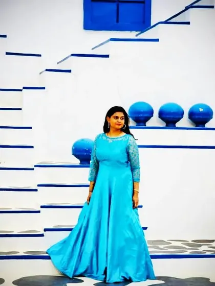A full-length shot of the sky blue gown, showcasing its beautiful sheen and flow. It's an affordable rental option for a high-end look.