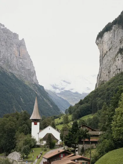 The iconic church in a Swiss valley, a key part of Punar and Malhar's elopement story. The dramatic landscape adds a sense of awe and wonder to their special day.
