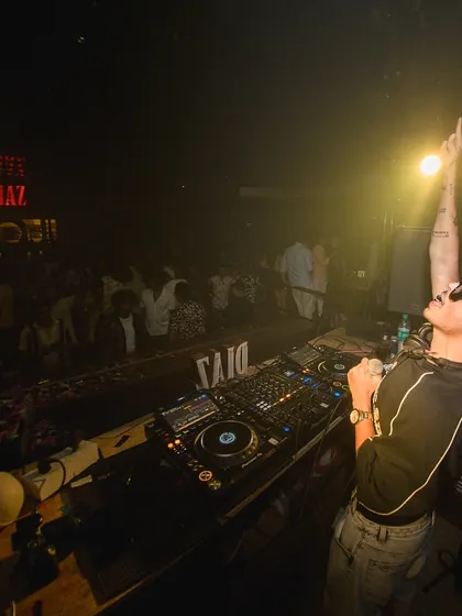 On the mic at Diaz, pointing to the sky. I'm always interacting with the crowd, making sure the energy never drops.