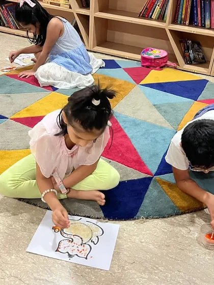 Finding a comfy spot on the floor to finish their Ganesh Chaturthi artwork. I encourage kids to get comfortable and let their creativity flow.
