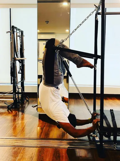 Using the Cadillac to achieve a deep stretch and build spinal mobility. A flexible body is a strong body.