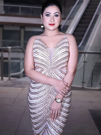 A classic pose in the rose gold sequin gown, showcasing its timeless glamour and modern design.