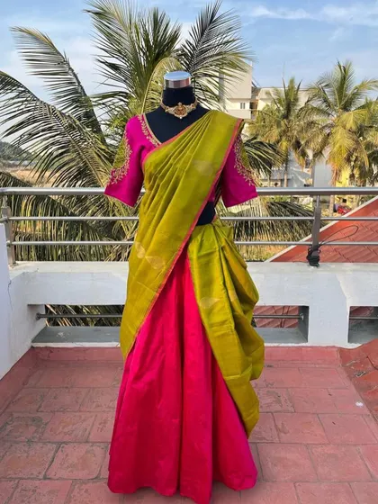 A full view of the pink and green half saree.