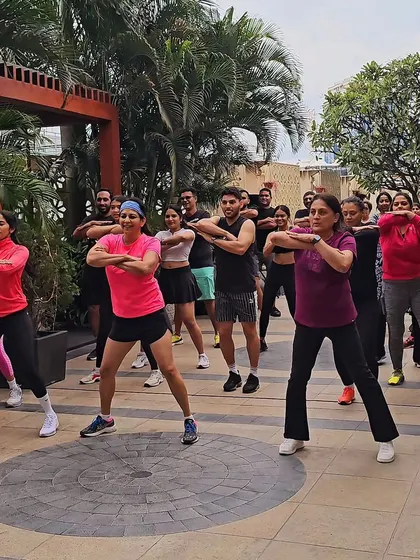 A wide shot of the team moving in sync. This visual demonstrates my ability to lead and energize large corporate groups effectively.