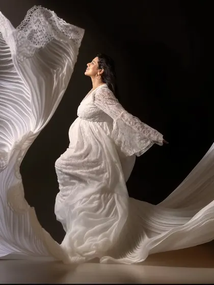 Grace in every fold, strength in every step. This portrait captures the quiet power of motherhood in motion, where the flowing white fabric seems to whisper a story of elegance and emotion.
