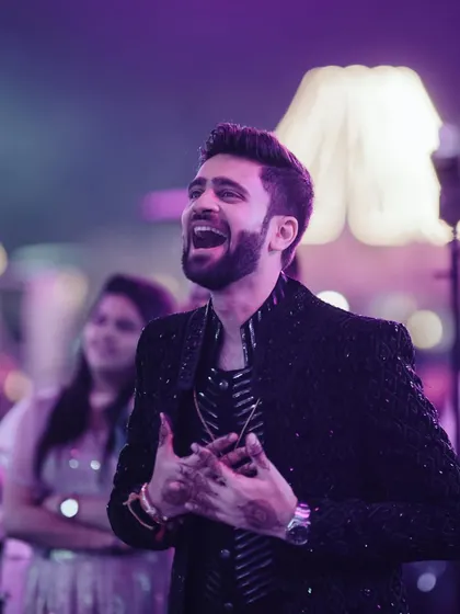 The groom's pure, uninhibited joy as he watches the Sangeet performances. Capturing these reactions is a key part of telling the full story of the night.