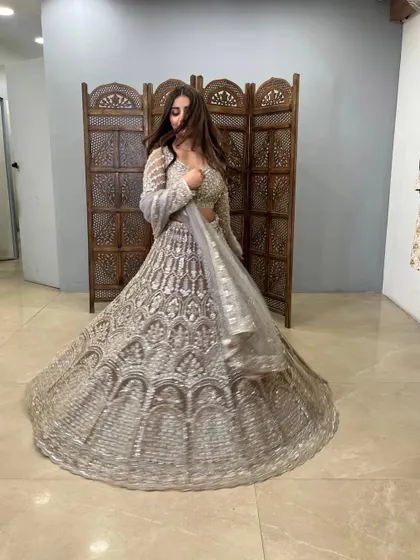 A dynamic shot capturing the movement and sparkle of this stunning grey lehenga.