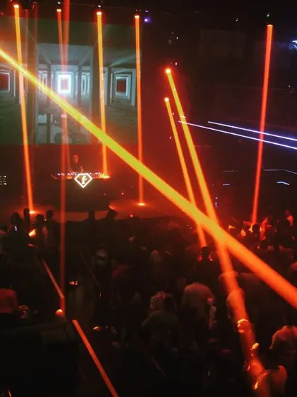 The light production at F Superclub is world-class. These orange lasers create a stunning visual that complements the driving beats of my set.