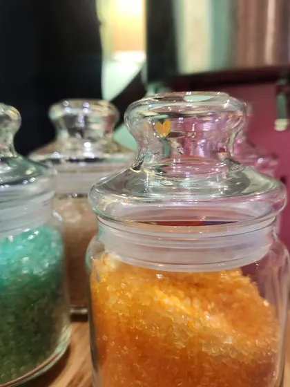 Jars of colorful flavored sugar for the candy floss machine. Kids can choose their favorite color and flavor for a personalized treat.