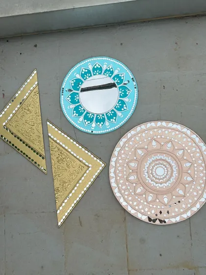 A collection of finished Lippan and mirror art pieces, showing the variety of shapes and designs you can create.