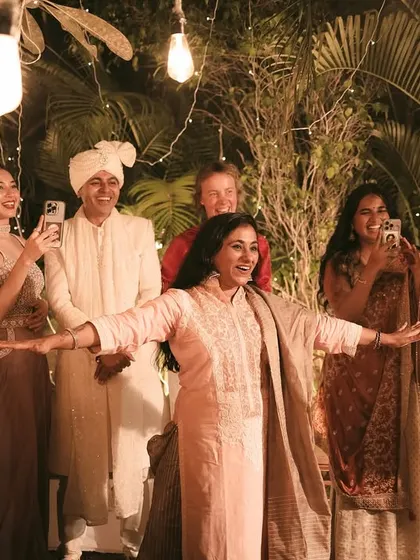 The joy of family and friends as they celebrate the couple's union under a canopy of fairy lights.