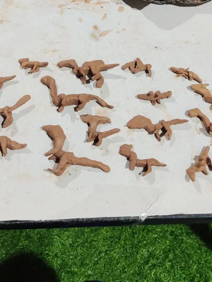 A whole herd of clay dinosaurs ready for adventure. In my kids clay classes, we often build themes around their interests, which makes the creative process even more exciting and personal for them.