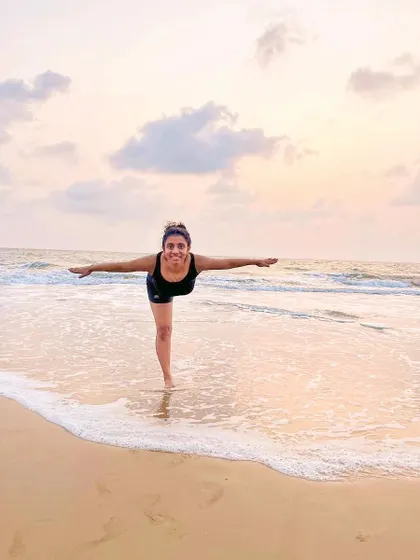 "We can only do small things with great love." A simple moment of joy and balance in Virabhadrasana III (Warrior III) at the beach, embracing the love for yoga.